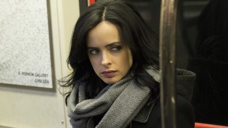 Krysten Ritter as Jessica Jones sitting in subway
