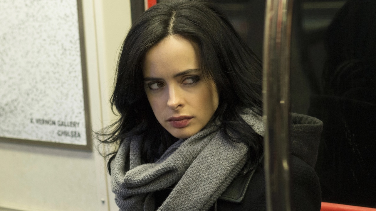 Krysten Ritter as Jessica Jones sitting in subway