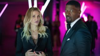 Cameron Diaz and Jamie Foxx look concerned while standing in a purple lit room dressed to the nines in Back In Action.