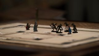 Dungeons and Dragons pieces on a game board in Stranger Things.