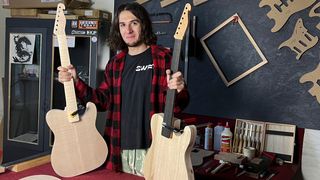 Nikita Zhemerenko poses with his SWFT Guitars in his workshop