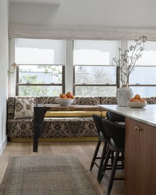 A kitchen with a muted kitchen rug