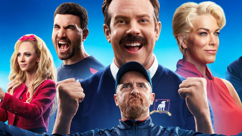 (L to R) Juno Temple as Keeley Jones, Brett Goldstein as Roy Kent, Jason Sudeikis as Ted Lasso, Brendan Hunt as Coach Beard and Hannah Waddingham as Rebecca Welton in Ted Lasso season 3&#039;s poster art