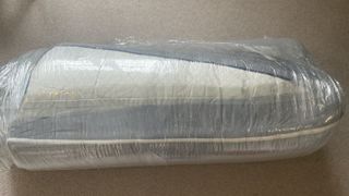 The Nectar Memory Foam Mattress photographed in its vacuum sealed plastic packaging during the unboxing part of our review