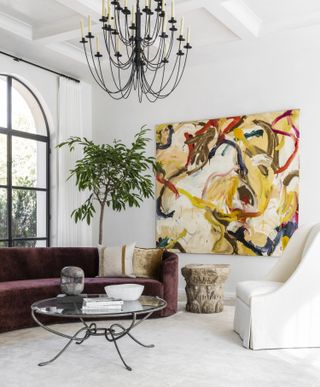 A living room with a large art piece