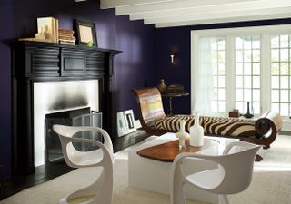 A living room with a purple wall and crr