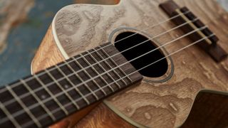 Close up of ukulele on wooden background