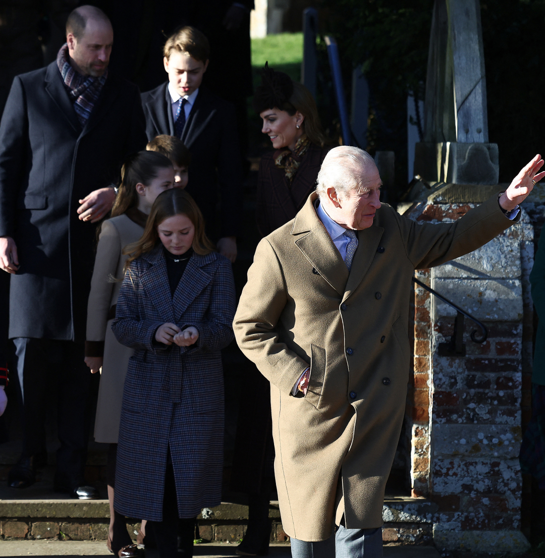King Charles waving outside church with William and Kate behind him