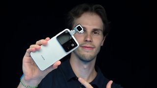 A man holding the Honor Robot Phone in his hand