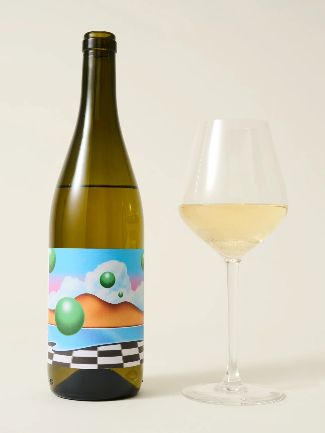 A bottle of white wine with a colorful label from OTHER beside a wine glass