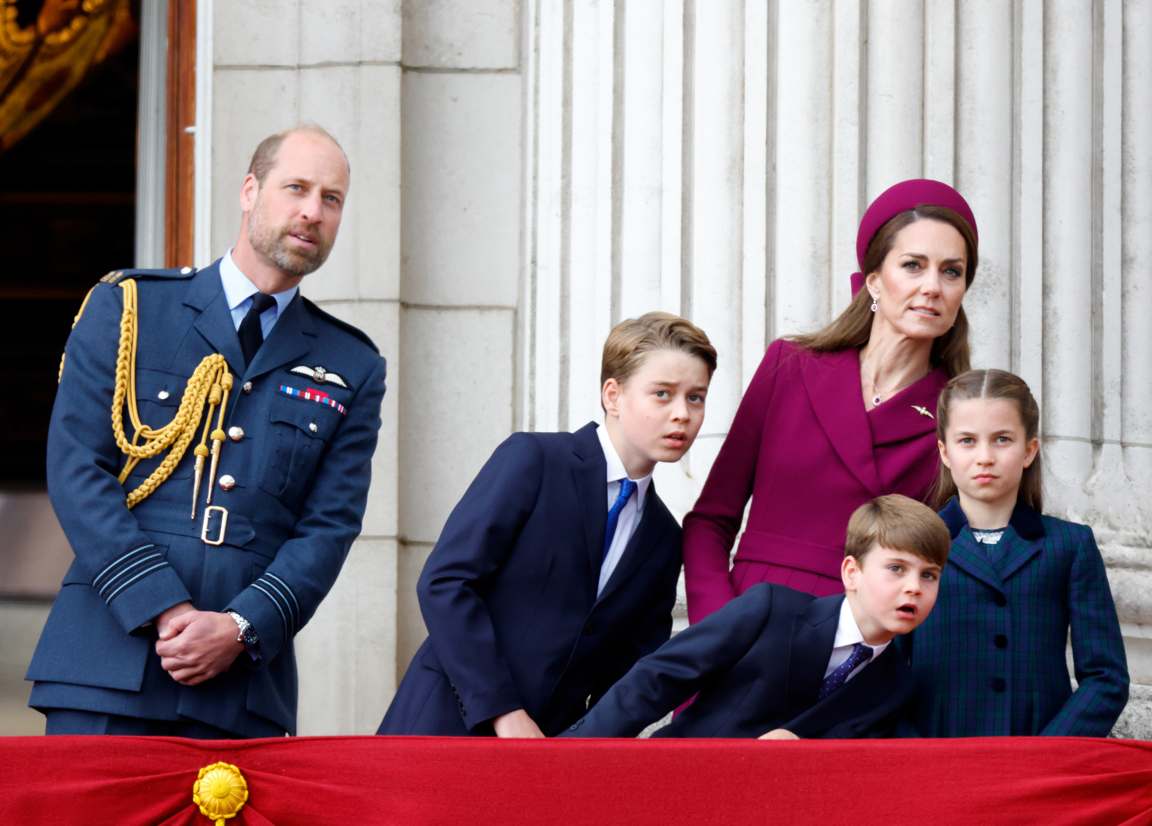 Prince William, Prince George, Princess Kate, Prince Louis and Princess Charlotte leaning to the side on the balcony at Buckingham Palace