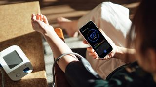 Woman using a blood pressure monitor at home