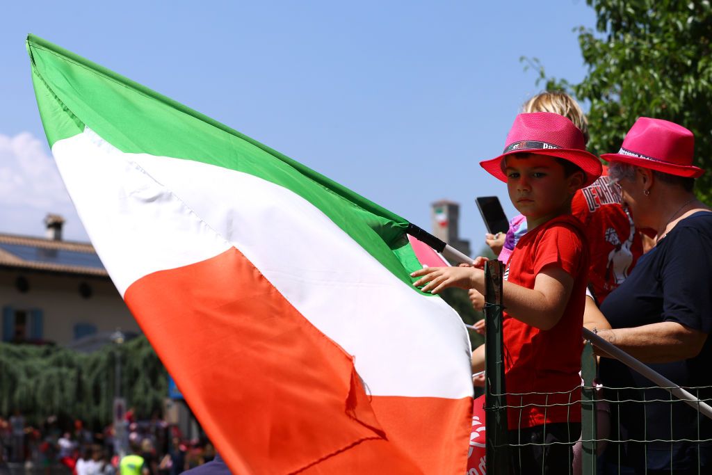 SANTUARIO DI CASTELMONTE ITALY MAY 27 A kid waits for the peloton to pass during the 105th Giro dItalia 2022 Stage 19 a 178km stage from Marano Lagunare to Santuario di Castelmonte 577m Giro WorldTour on May 27 2022 in Santuario di Castelmonte Italy Photo by Michael SteeleGetty Images