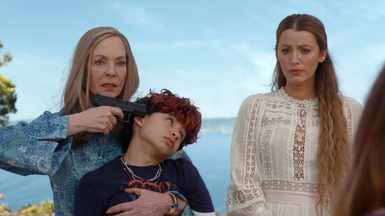 An angry Allison Janney holds Ian Ho at gunpoint next to a worried Blake Lively, in Another Simple Favor.