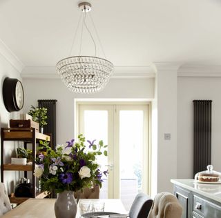 room with white walls and chandelier