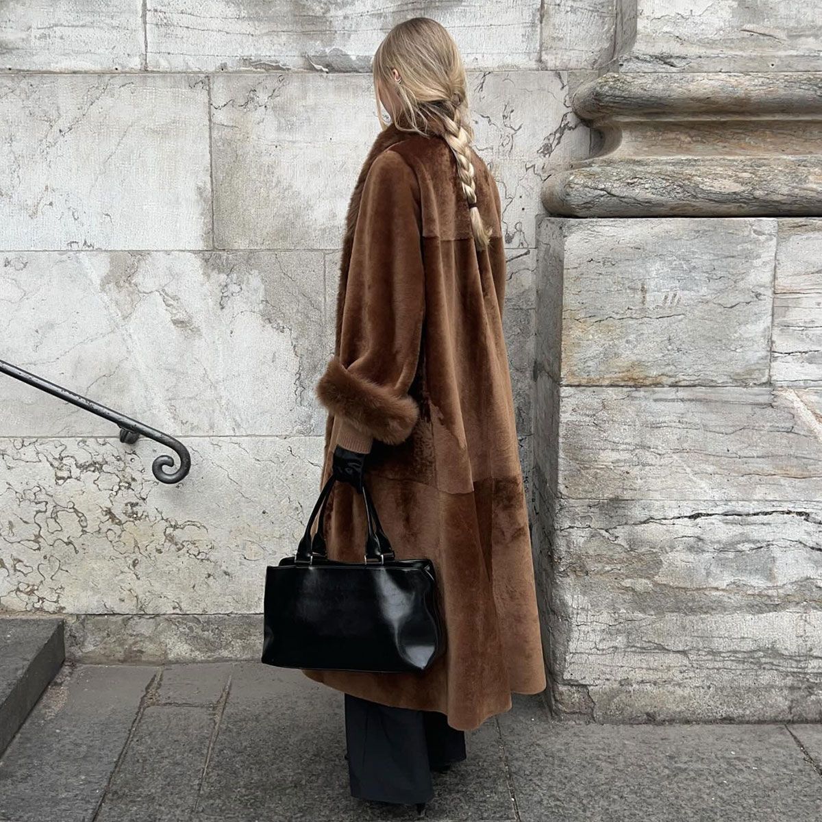 @signeemilieolesen in brown nour hammour shearling coat shown from the back with a braid