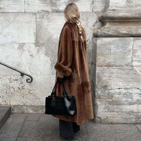 @signeemilieolesen in brown nour hammour shearling coat shown from the back with a braid