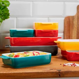 colourful cast iron stoneware dishes on wooden table