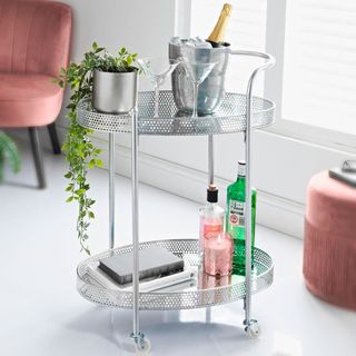 Drinks trolley with white walls bottles and book