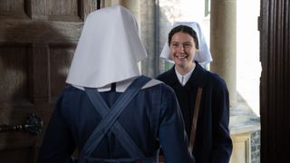 Molly Vevers in a dark coat and white veil as Sister Catherine arrives at Nonnatus House and is greeted by Jenny Agutter in a blue habit and pinafore as Sister Julienne in Call the Midwife.