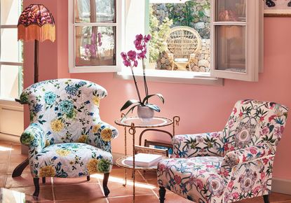 patterned armchairs in a pink living room