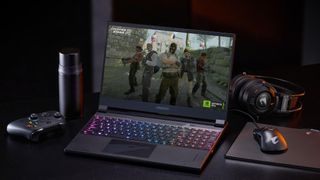 Gigabyte AORUS 15 gaming laptop on a desk with accessories
