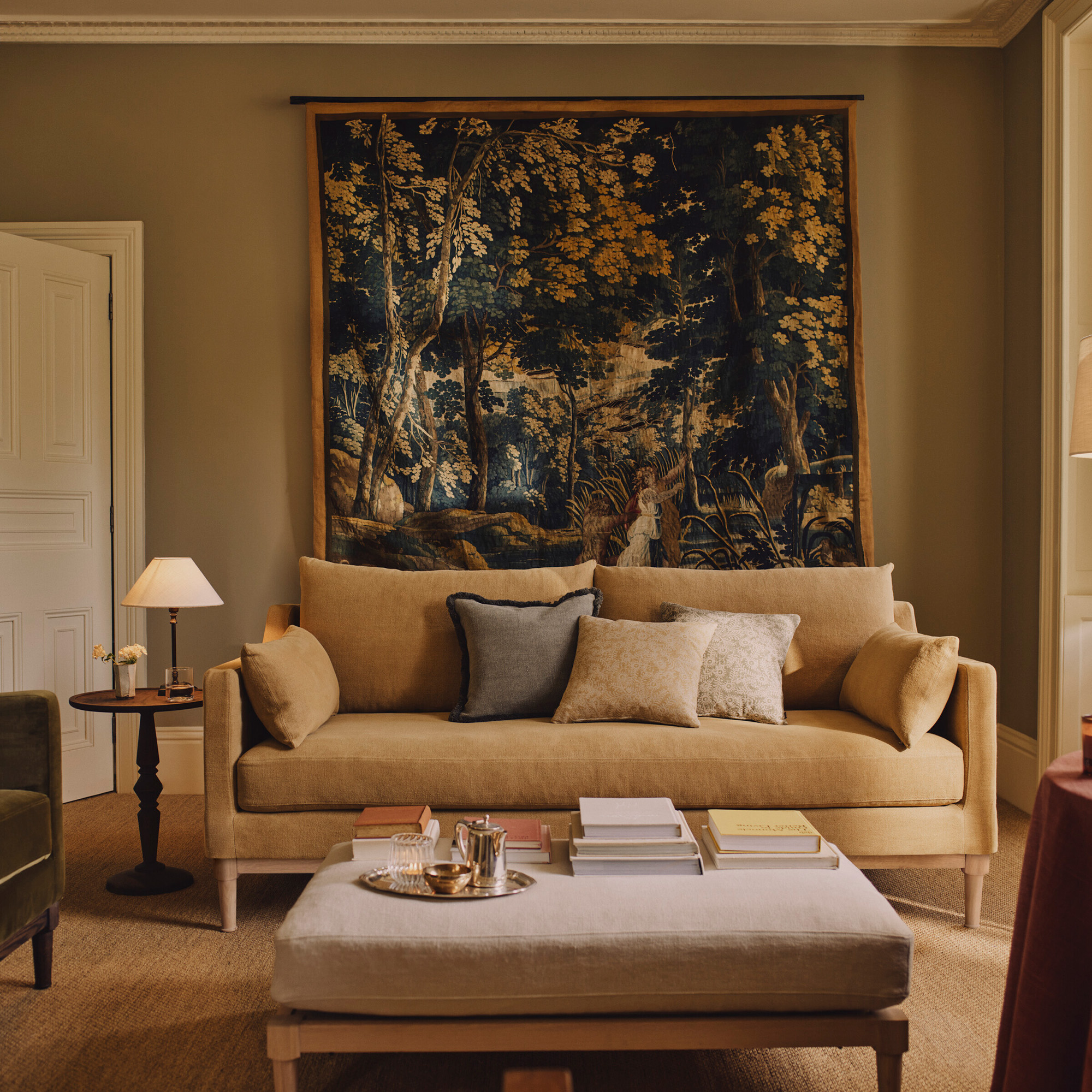tapestry in neutral living room with beige walls and linen sofa