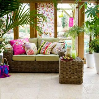 wooden conservatory with sofa and potted plants