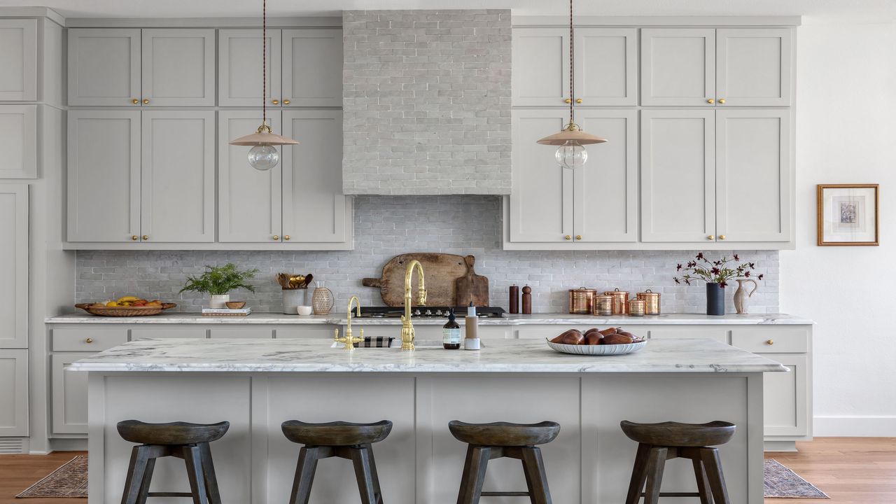 small, bright kitchen with bright countertop and gold hardware