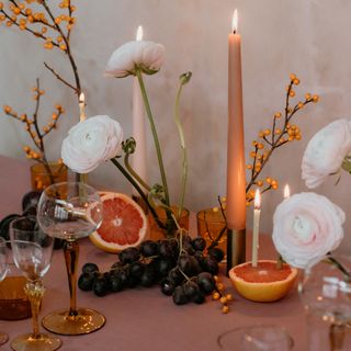 dining table with fruits and candles