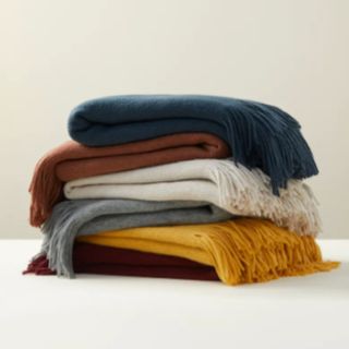 Four Upwest x Nordstrom The Softest Throw Blankets piled on top of each other