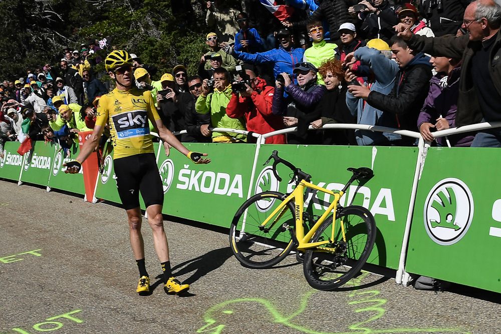 Chris Froome waits for his team car for a new bike during stage 12 at the Tour de France