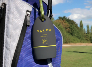 Solex sunscreen hanging on a golf bag