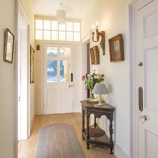 hallway with wooden floor and white door