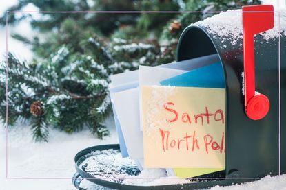 A snowy letterbox with a letter poking out addressed to the North Pole