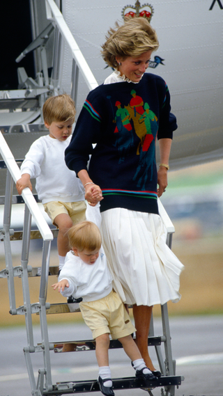 Princess Diana With Her Sons Prince William And Prince Harry Coming Down The Steps Of A Royal Flight Airplane At Aberdeen Airport At The Start Of Their Holidays In Scotland. Her Jumper Has A Motif Of A Polo Player in 1986