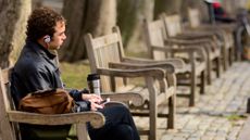 A man sits on a park bench in Philadelphia