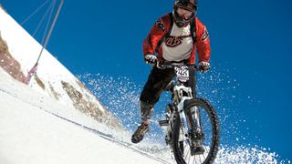 image of a mountain biker on snow