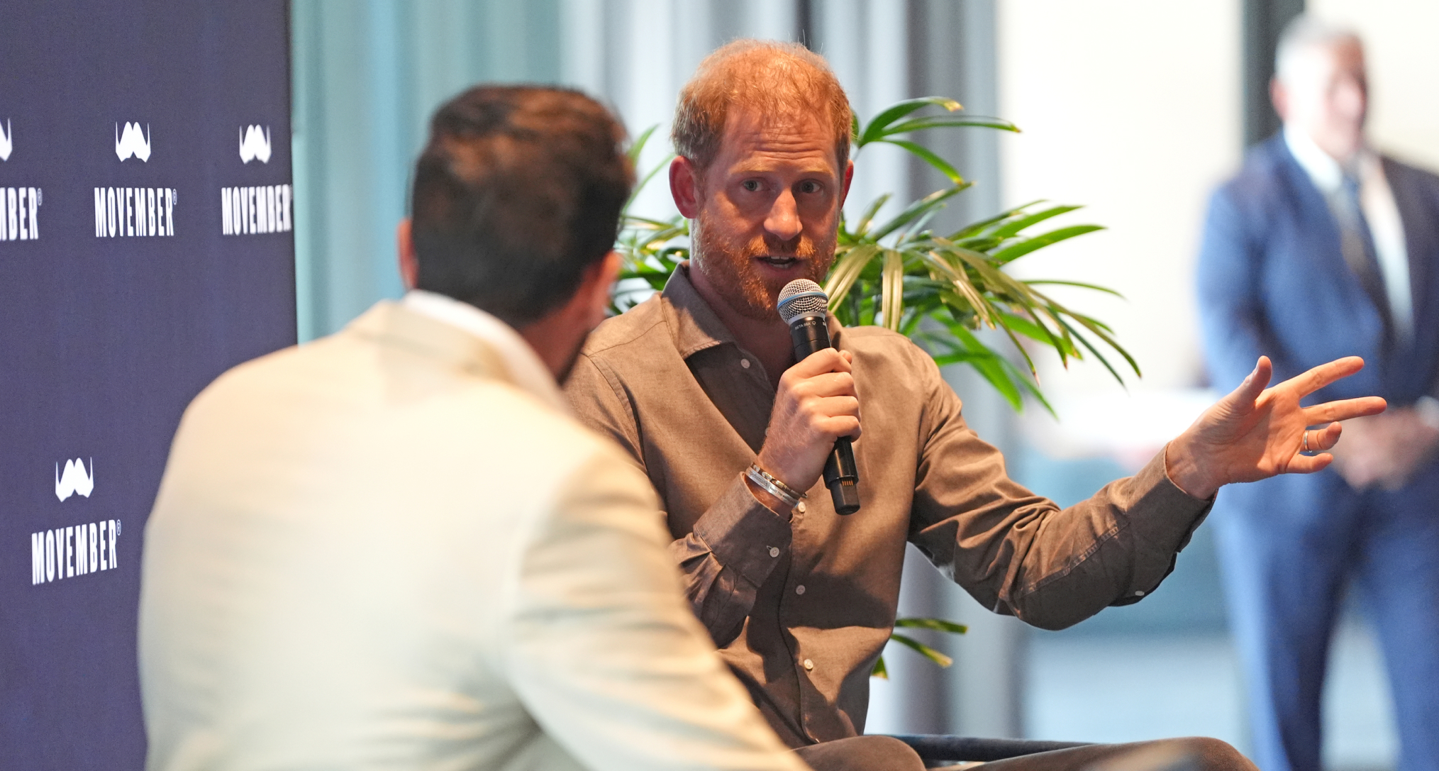 Prince Harry speaking into a microphone 