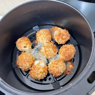 Image of lakeland air fryer during testing with mozzarella balls