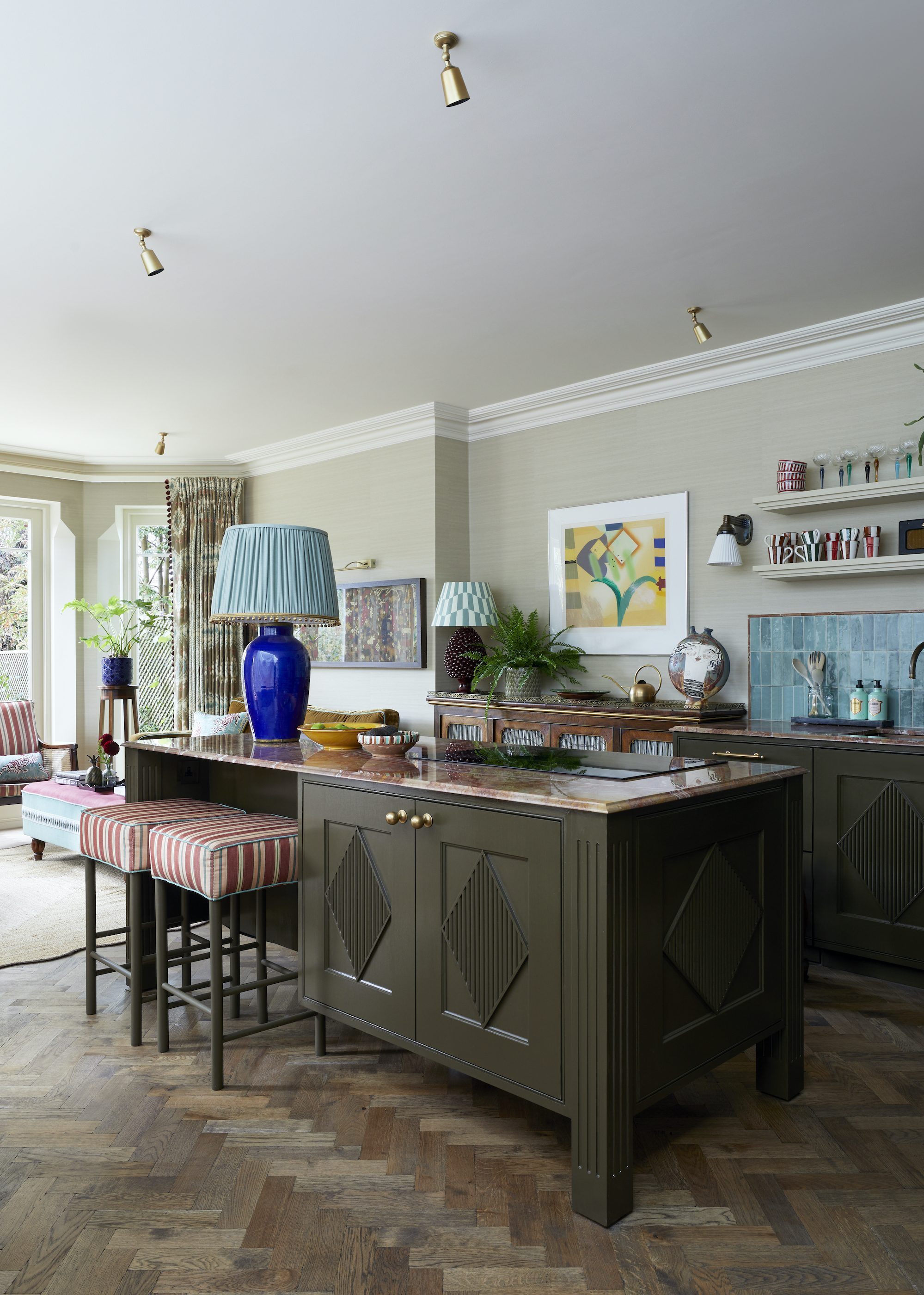 Kitchen designed to look like a living room with lamps on the island and vintage sideboard