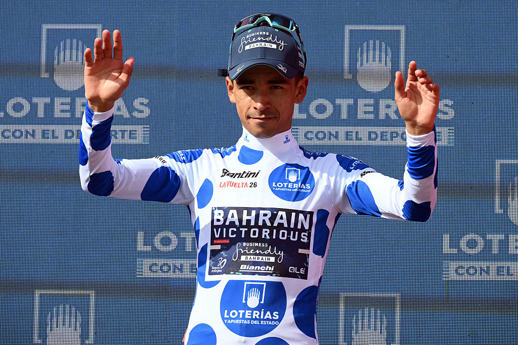 Team Bahrain's Colombian rider Santiago Buitrago celebrates on the podium wearing the best climber ranking leader's dotted jersey after the 10th stage of the Vuelta a Espana 2026 cycling tour, a 184,7 km race between Alcaraz and Elche de la Sierra, on September 1, 2026. (Photo by JOSE JORDAN / AFP)