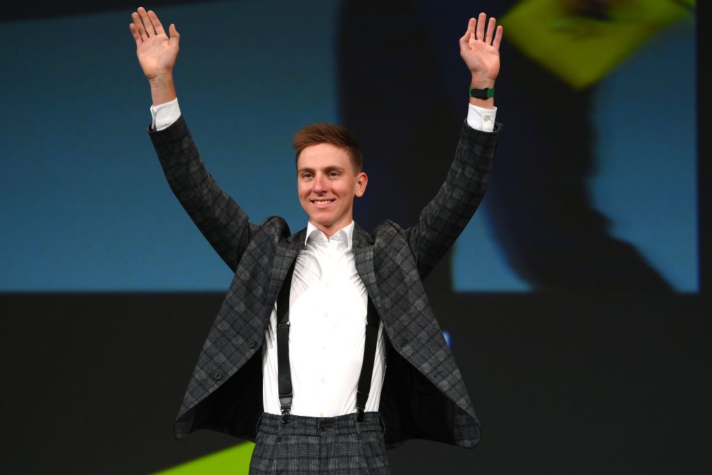 Tadej Pogacar waves to the crowd at the 2023 Tour de France presentation