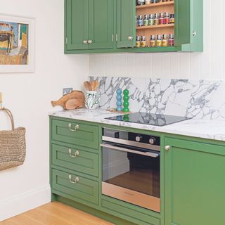small green kitchen with marble splashback