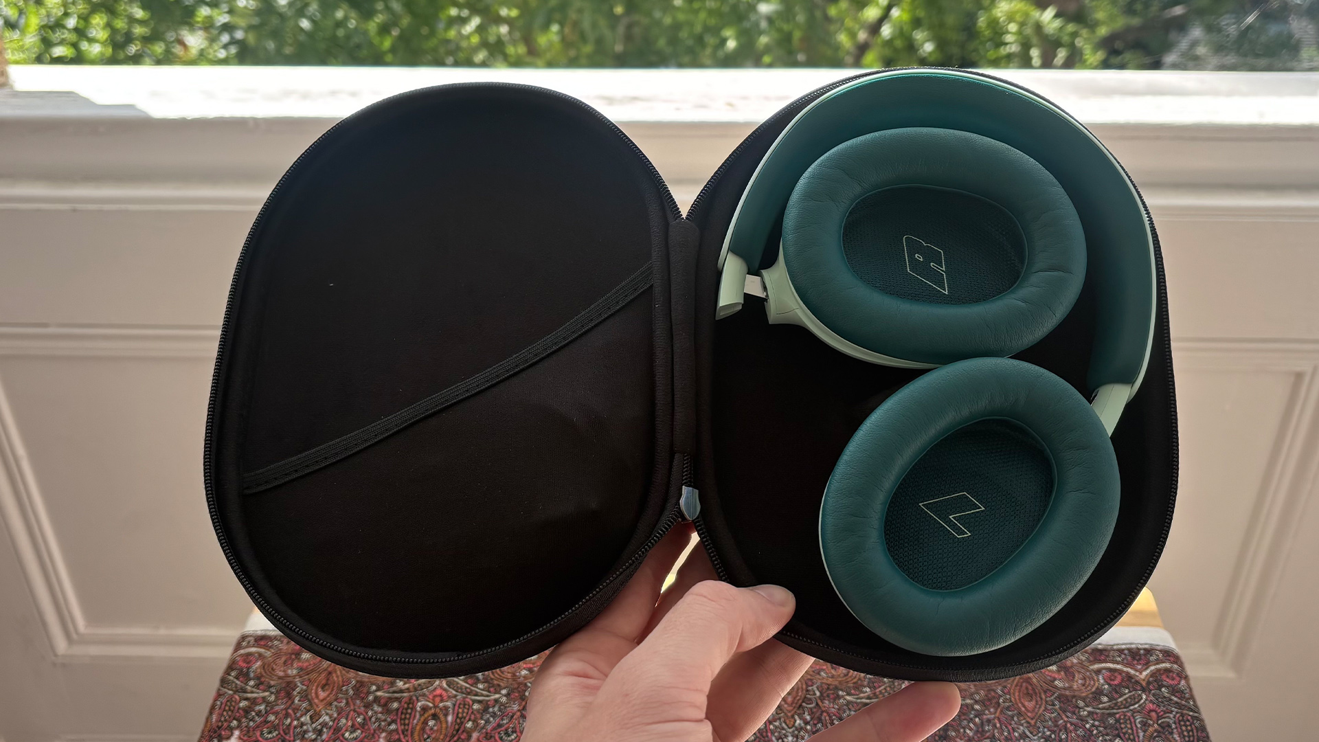 Bose QuietComfort Headphones (2nd Gen) over-ear headphones in case held in hand