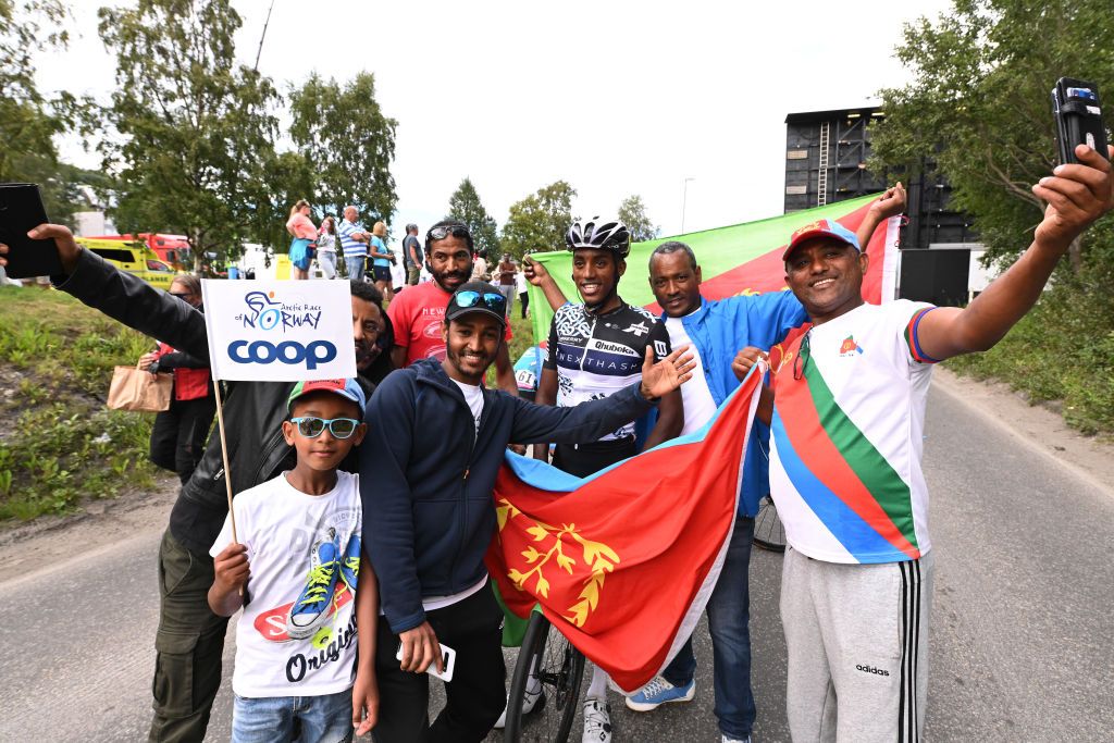 HARSTAD NORWAY AUGUST 08 Henok Mulubrhan of Eritrea and Team Qhubeka Nexthash celebrates at finish line with compatriots during the 8th Arctic Race Of Norway 2021 Stage 4 a 1635km stage from Gratangen to Harstad 54m ArcticRace on August 08 2021 in Harstad Norway Photo by Stuart FranklinGetty Images