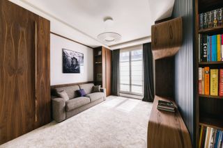 home office with sofa bed and walnut joinery