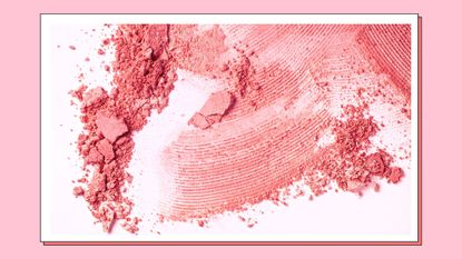 Bright coral and pink smudges of powdered blush on a pink background/ in a pink template