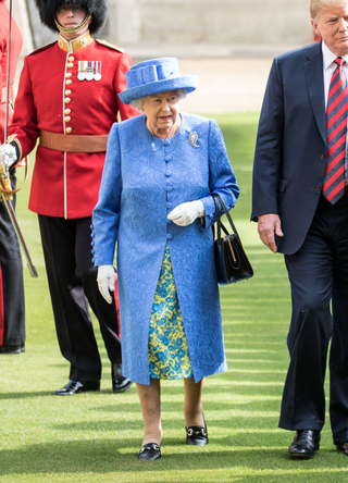 U.S. President Donald Trump and Britain's Queen Elizabeth II inspect a Guard of Honour, formed of the Coldstream Guards at Windsor Castle on July 13, 2018 in Windsor, England