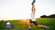 Man performing dumbbell overhead lunges on grass during outdoor workout